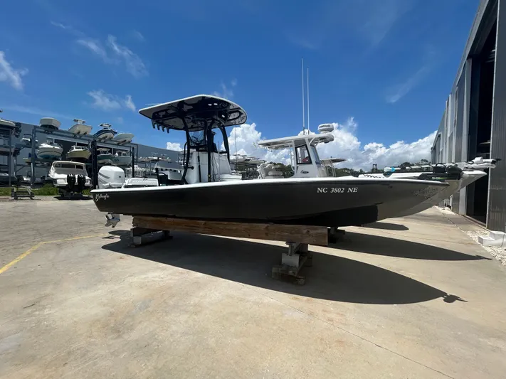  Yacht Photos Pics 2021 Yellowfin 24 Bay CE boat on display under clear blue sky.
