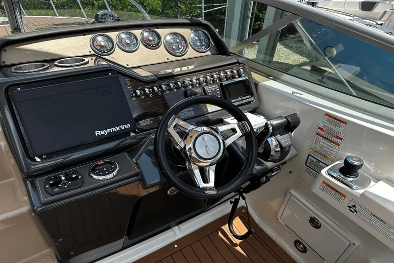 Parce Yacht Photos Pics Cockpit of 2016 Sea Ray 310 Sundancer with steering wheel and Raymarine navigation system.