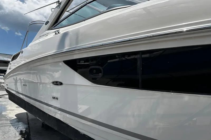 Parce Yacht Photos Pics 2016 Sea Ray 310 Sundancer boat side view under a cloudy sky.