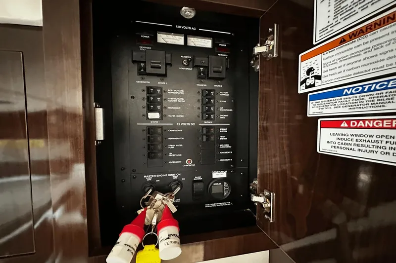 Parce Yacht Photos Pics Electrical panel inside 2016 Sea Ray 310 Sundancer boat with warning labels and keys.