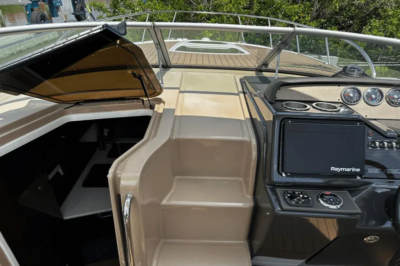 Parce Yacht Photos Pics 2016 Sea Ray 310 Sundancer helm with Raymarine navigation system and cabin entrance.