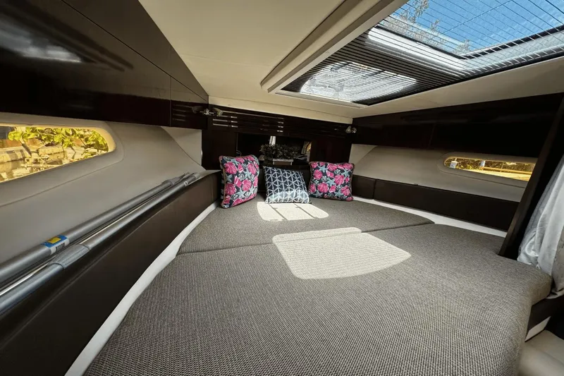 Parce Yacht Photos Pics Interior of 2016 Sea Ray 310 Sundancer with skylight and decorative pillows.