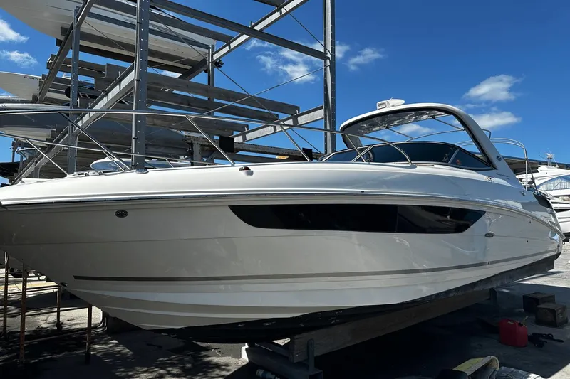 Parce Yacht Photos Pics 2016 Sea Ray 310 Sundancer boat on dry dock under clear blue sky.