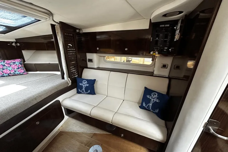 Parce Yacht Photos Pics Interior of 2016 Sea Ray 310 Sundancer with cozy seating and nautical decor.