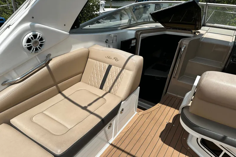 Parce Yacht Photos Pics Luxurious interior of 2016 Sea Ray 310 Sundancer with beige seating and wood flooring.