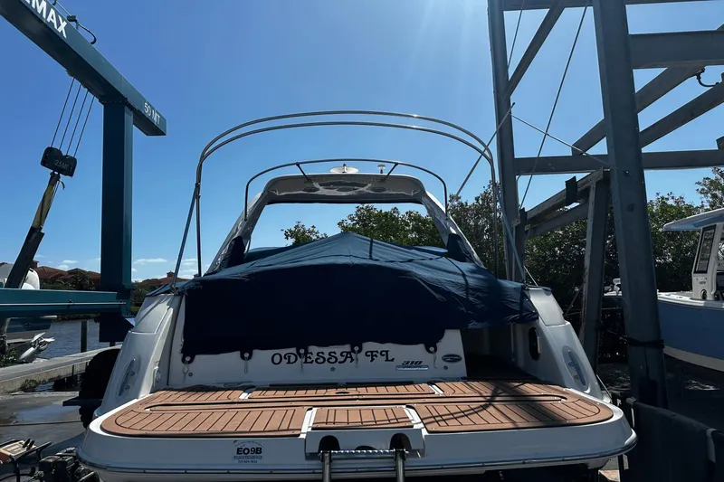 Parce Yacht Photos Pics 2016 Sea Ray 310 Sundancer docked, covered, with clear blue sky background.