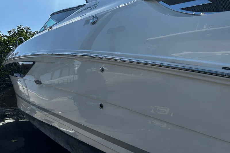 Parce Yacht Photos Pics 2016 Sea Ray 310 Sundancer boat side view, sleek white exterior.