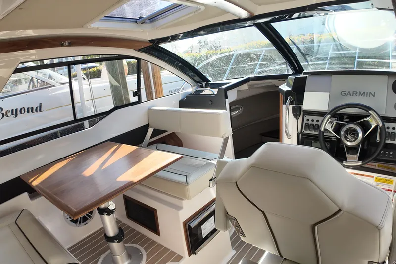  Yacht Photos Pics Interior of 2026 Solara S-250 Coupe boat with modern helm and seating area.
