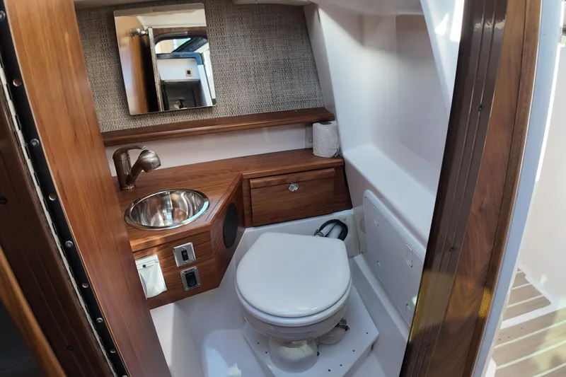  Yacht Photos Pics Luxurious bathroom interior of 2026 Solara S-250 Coupe with wood accents and modern fixtures.