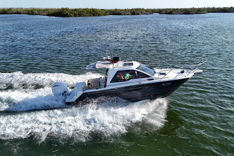  Yacht Photos Pics 2026 Solara S-250 Coupe cruising on open water, showcasing sleek design and performance.