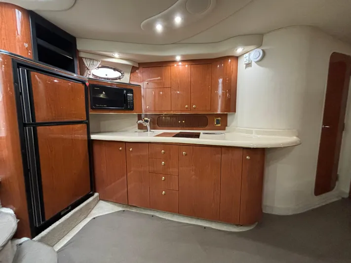  Yacht Photos Pics 1998 Sea Ray 400 Sundancer yacht kitchen with wood cabinets and modern appliances.