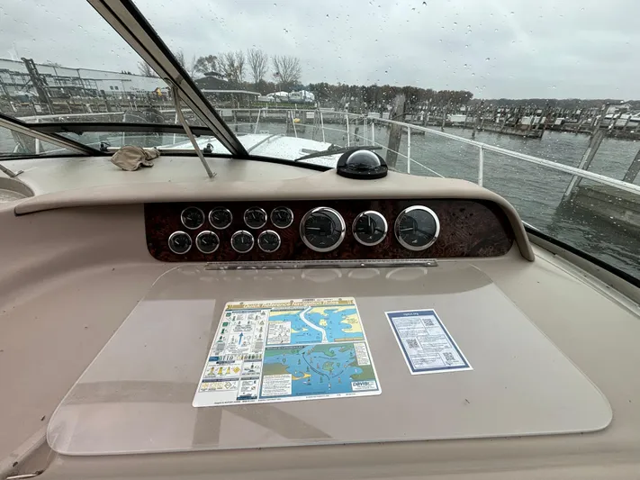  Yacht Photos Pics 1998 Sea Ray 400 Sundancer dashboard with gauges and navigation map, docked by the water.