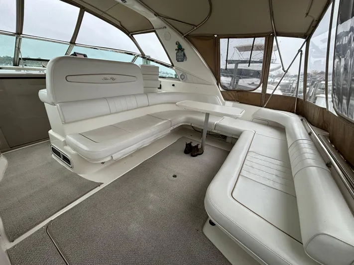  Yacht Photos Pics Spacious interior of 1998 Sea Ray 400 Sundancer with white seating and panoramic windows.