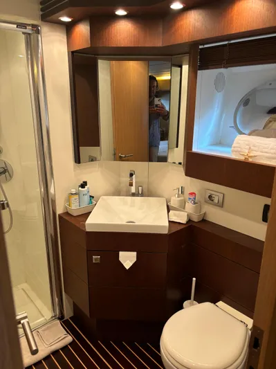  Yacht Photos Pics Luxurious bathroom in 2006 Maiora 20S yacht with modern fixtures and elegant wood accents.