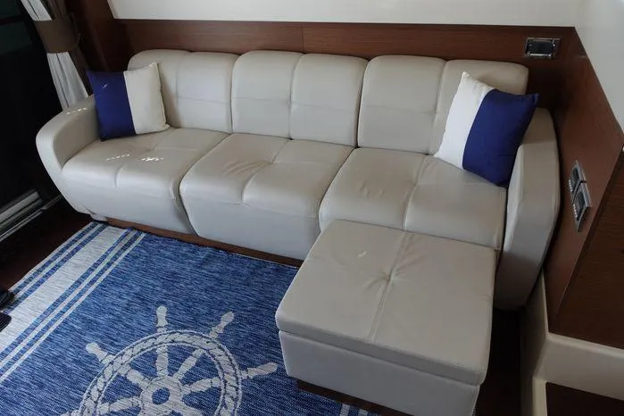  Yacht Photos Pics Luxurious white leather sofa on Sea Ray 450 Sedan Bridge, 2012 model, with nautical-themed decor.