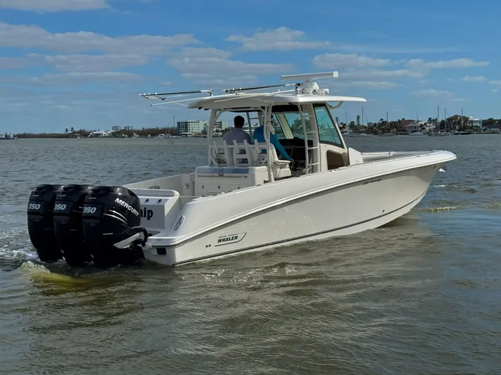 Crews Ship Yacht Photos Pics 2015 Boston Whaler 350 Outrage boat cruising on calm waters.