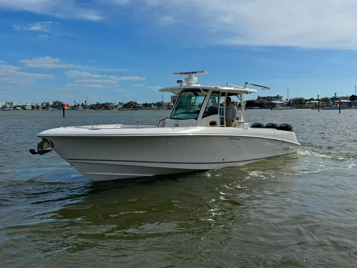 Crews Ship Yacht Photos Pics 2015 Boston Whaler 350 Outrage boat cruising on a calm waterway.