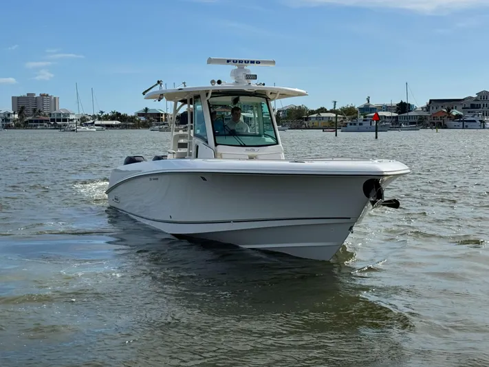 Crews Ship Yacht Photos Pics 2015 Boston Whaler 350 Outrage boat cruising on a calm waterway.