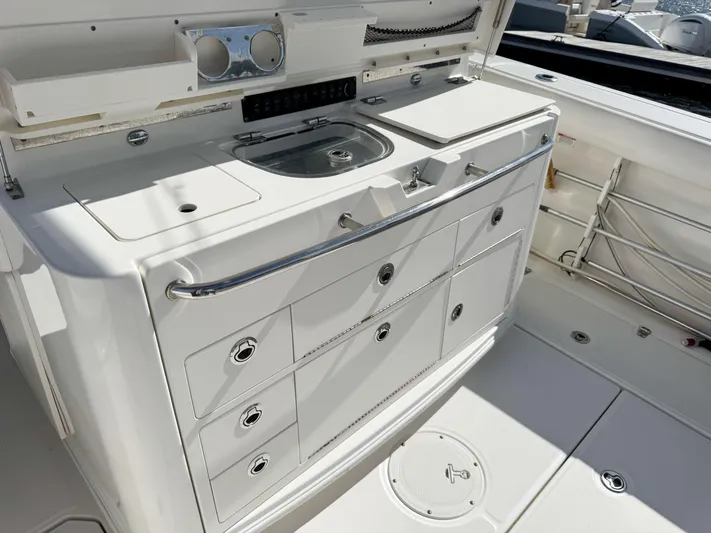 Crews Ship Yacht Photos Pics 2015 Boston Whaler 350 Outrage boat interior with sink and storage drawers.