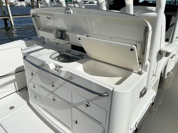 Crews Ship Yacht Photos Pics 2015 Boston Whaler 350 Outrage boat with open storage and sink area.