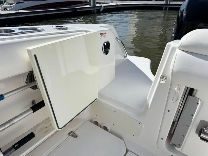 Crews Ship Yacht Photos Pics 2015 Boston Whaler 350 Outrage boat interior with open storage compartment by the water.