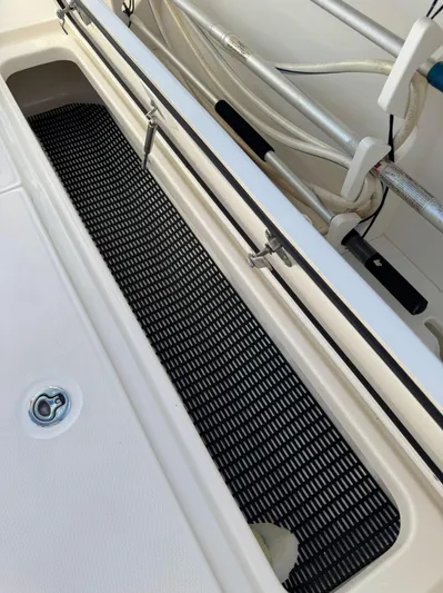 Crews Ship Yacht Photos Pics 2015 Boston Whaler 350 Outrage boat interior with storage compartment and fishing rod holders.