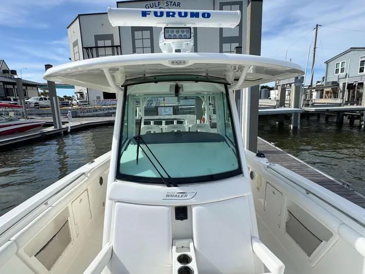 Crews Ship Yacht Photos Pics 2015 Boston Whaler 350 Outrage boat docked at marina, featuring Furuno navigation system.