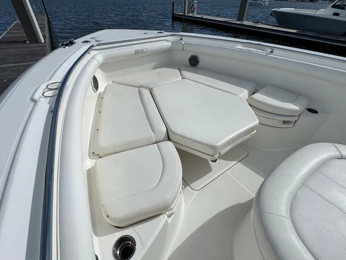 Crews Ship Yacht Photos Pics 2015 Boston Whaler 350 Outrage boat interior with white cushioned seating.