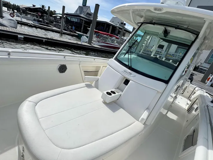 Crews Ship Yacht Photos Pics 2015 Boston Whaler 350 Outrage boat at marina, featuring spacious seating and sleek design.