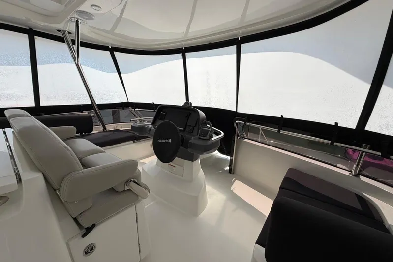 Superlux Yacht Photos Pics Interior of 2023 Aquila 42 Yacht with modern helm and seating area.