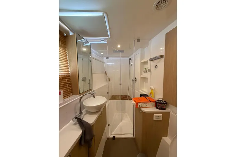 Superlux Yacht Photos Pics Modern bathroom in 2023 Aquila 42 Yacht with sleek fixtures and wooden accents.