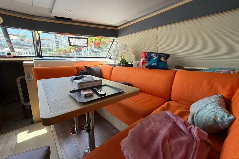 Superlux Yacht Photos Pics Interior of 2023 Aquila 42 Yacht with orange seating and dining table.