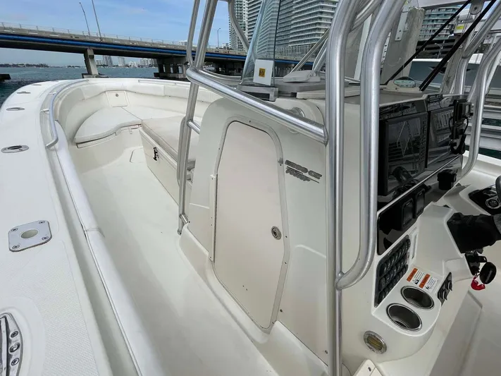 El Gringo Yacht Photos Pics 2004 Hydra-Sports 3300 CC boat interior with console and seating, docked near a bridge.