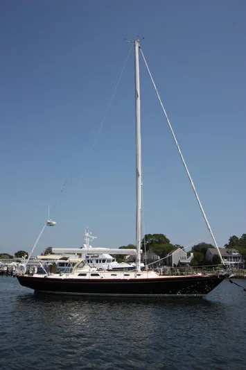 Regulus Yacht Photos Pics Hinckley Sou'wester 51 sailboat, 1993 model, on calm water with clear blue sky.