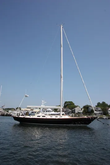 Regulus Yacht Photos Pics Hinckley Sou'wester 51 sailboat, 1993 model, docked in a serene harbor setting.
