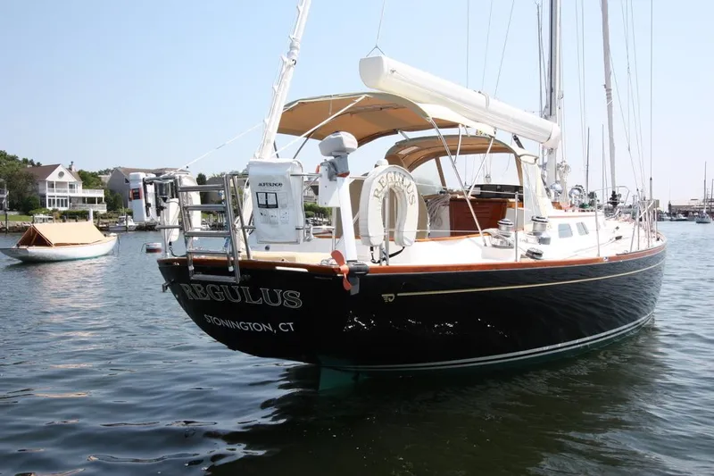 Regulus Yacht Photos Pics 1993 Hinckley Sou'wester 51 sailboat docked in a serene marina setting.