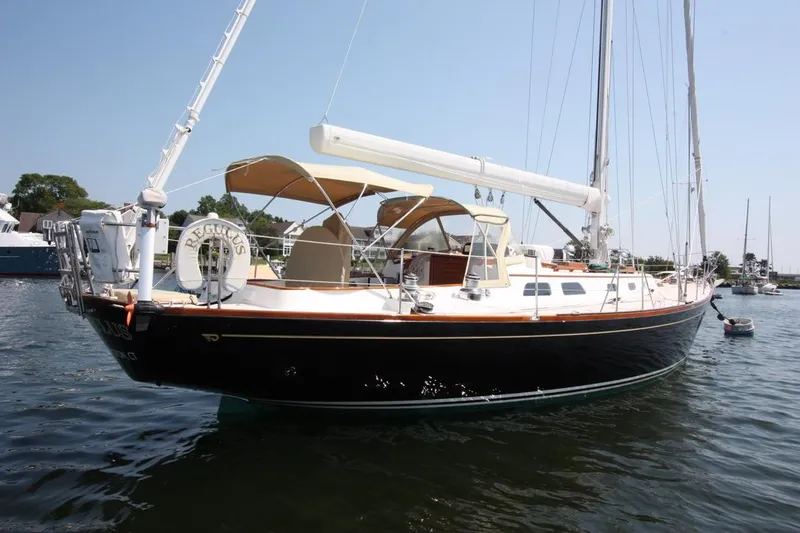 Regulus Yacht Photos Pics 1993 Hinckley Sou'wester 51 sailboat on calm water, featuring elegant design and spacious deck.