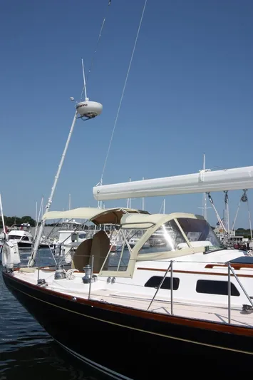 Regulus Yacht Photos Pics Hinckley Sou'wester 51 sailboat, 1993 model, docked in a marina under clear blue skies.