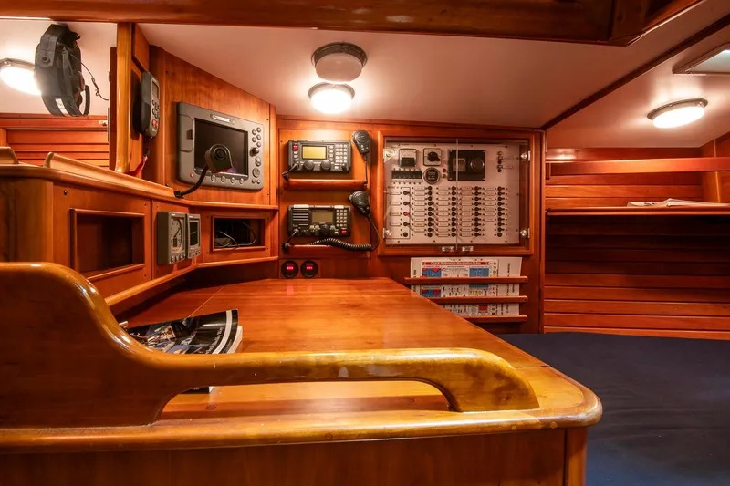 Regulus Yacht Photos Pics Navigation station of 1993 Hinckley Sou'wester 51 yacht with wooden interior and communication equipment.