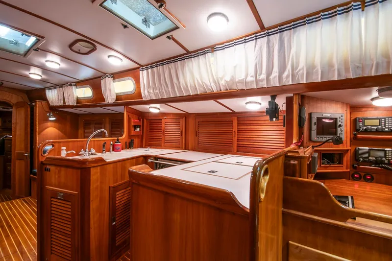 Regulus Yacht Photos Pics Luxurious 1993 Hinckley Sou'wester 51 yacht interior with wood finish and modern amenities.