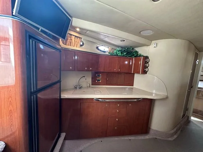  Yacht Photos Pics Interior of 2000 Sea Ray 410 Sundancer yacht with kitchenette and wood cabinetry.