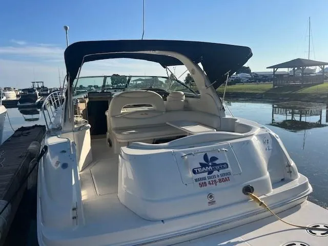  Yacht Photos Pics 2000 Sea Ray 410 Sundancer docked, featuring spacious seating and canopy.