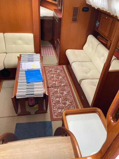 Morgan's Moon Yacht Photos Pics Interior of 2008 Hallberg-Rassy 43 yacht with cozy seating and wooden finishes.