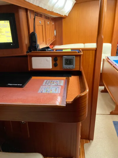 Morgan's Moon Yacht Photos Pics Interior of 2008 Hallberg-Rassy 43 yacht with navigation station and seating area.