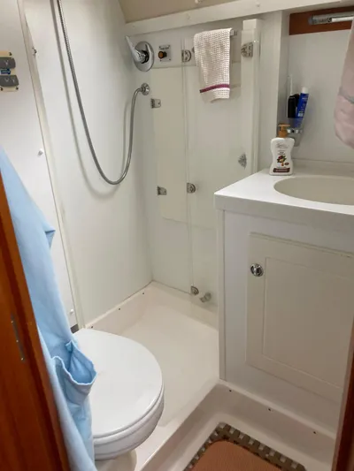 Morgan's Moon Yacht Photos Pics Bathroom interior of 2008 Hallberg-Rassy 43 yacht, featuring shower, sink, and toilet.