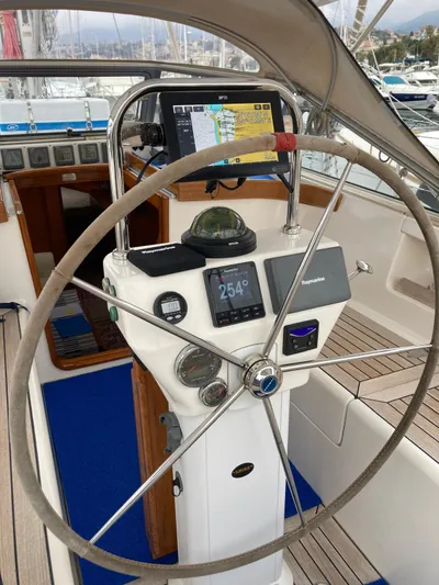 Morgan's Moon Yacht Photos Pics Steering wheel and navigation system of a 2008 Hallberg-Rassy 43 sailboat.