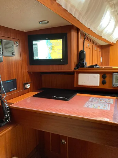 Morgan's Moon Yacht Photos Pics Navigation station inside 2008 Hallberg-Rassy 43 yacht with electronic display and communication equipment.