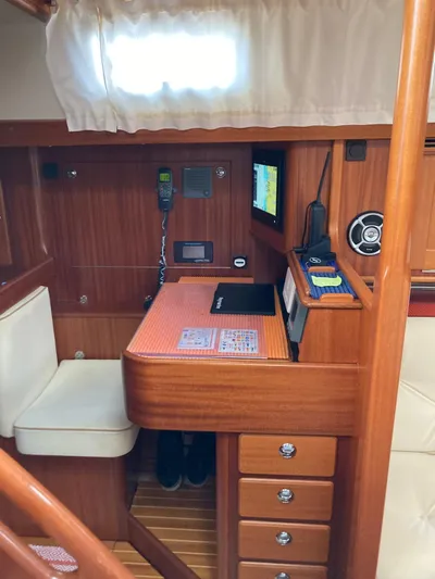 Morgan's Moon Yacht Photos Pics Hallberg-Rassy 43 (2008) yacht interior with navigation station and wooden cabinetry.