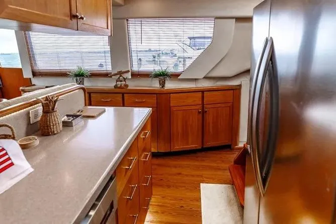  Yacht Photos Pics Luxurious kitchen interior of 2000 Pacific Mariner 65 Motoryacht with wooden cabinets and modern appliances.