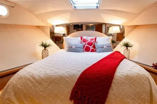  Yacht Photos Pics Luxurious bedroom interior of 2000 Pacific Mariner 65 Motoryacht with elegant bedding and decor.
